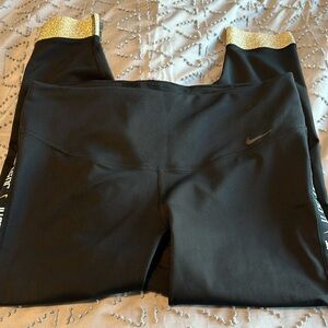 Nike leggings with logo detail and gold hem